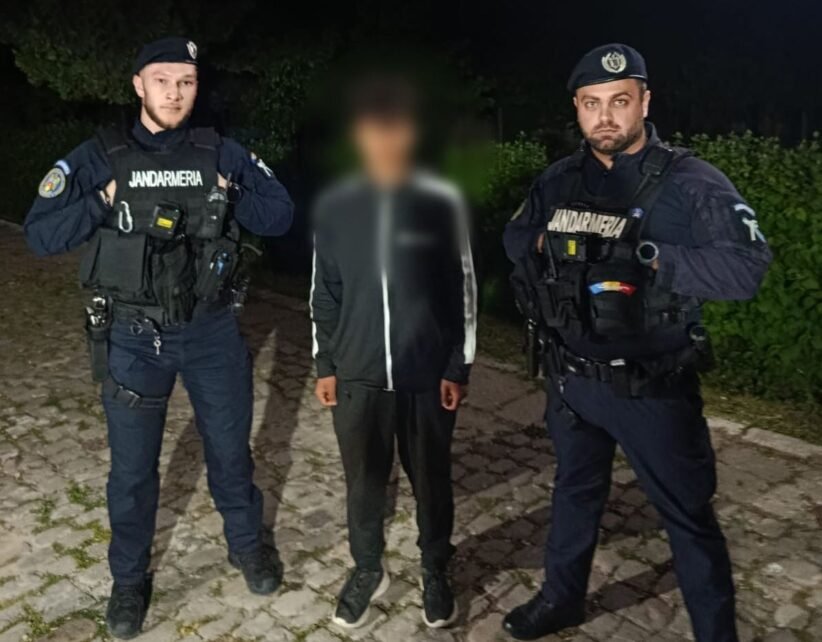 Two gendarmes in tactical gear flank a blurred civilian on a cobblestone path at night.