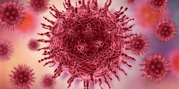 Close-up illustration of a red virus particle with spike proteins against a pink-purple blurred background.