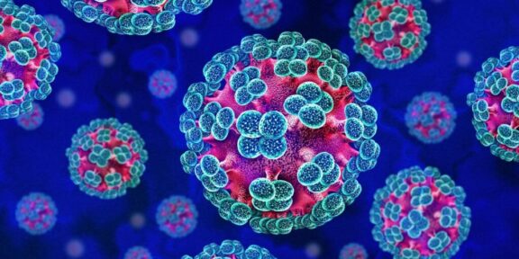 Color-enhanced illustration of pink viral particles with blue-green surface proteins floating in a blue background.