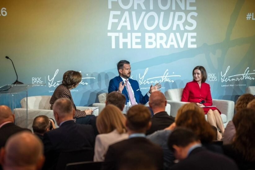 Panel discussion with three speakers on stage; backdrop reads 'Fortune Favours The Brave'.