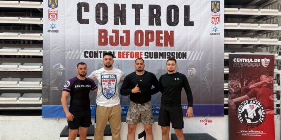 Four men stand on a winners podium in front of a banner that reads 'CONTROL BJJ OPEN', posing for a photo at a martial arts event.